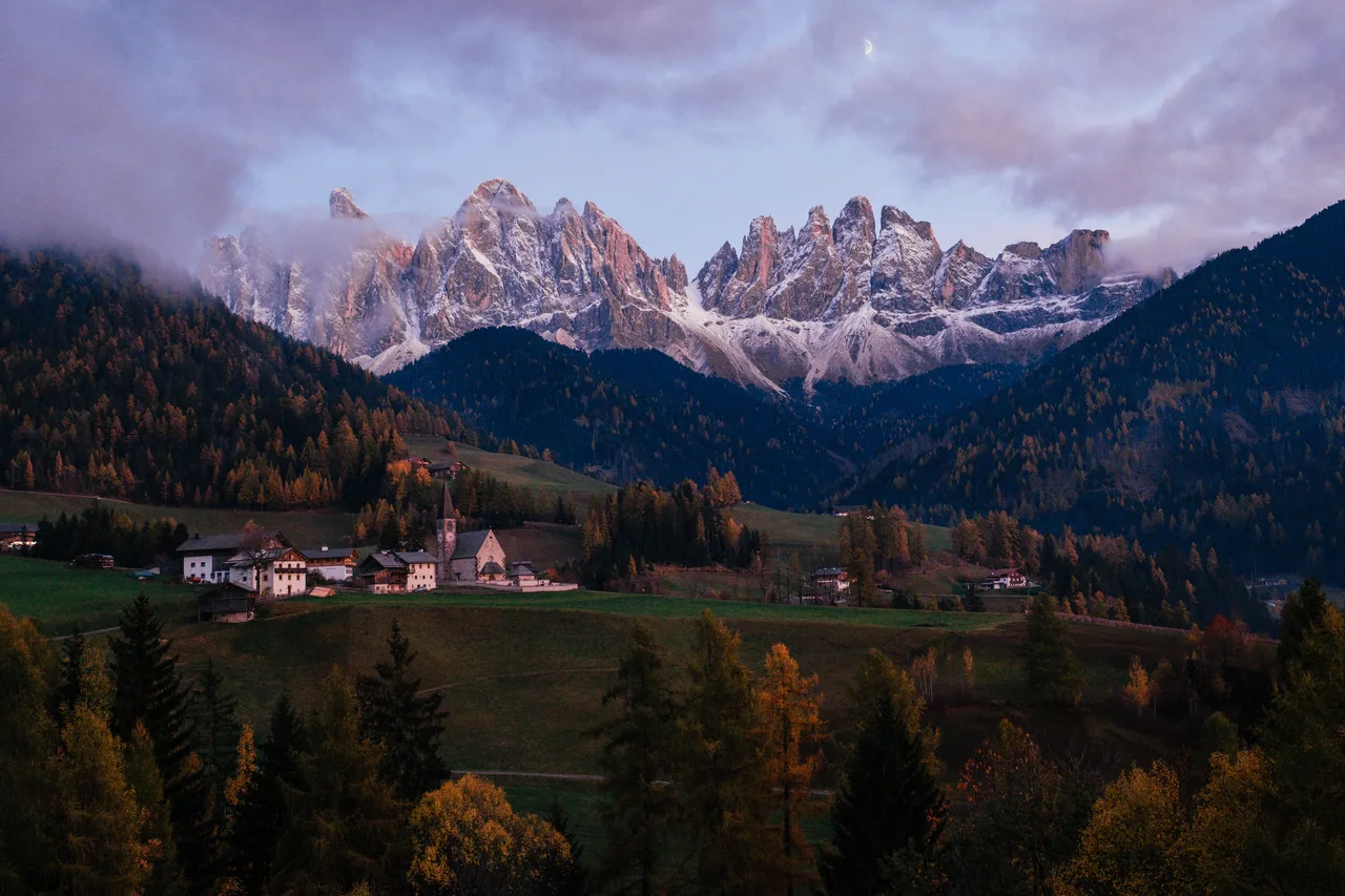 Dolomite spires above an autumn larch valley in northern Italy